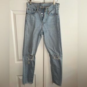 Distressed light blue denim straight leg jeans from Levi’s